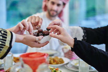 Muslim family having iftar together during Ramadan. - obrazy, fototapety, plakaty