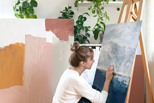 Woman painting abstract painting