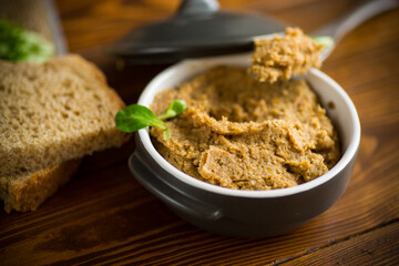 homemade meat pate in a ceramic bowl on a wooden table