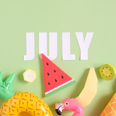 Exotic fruits made of paper on green background