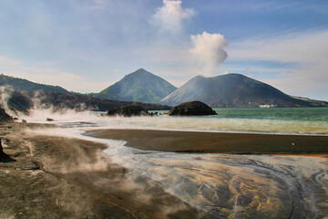 active volcano Tavurvur, sulphur covered beach, steaming water