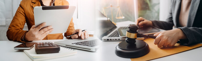 Business and lawyers discussing contract papers with brass scale on desk in office. Law, legal services, advice, justice and law concept picture with film grain effect