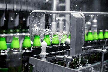 The process of filling beer into bottles on a production conveyor line