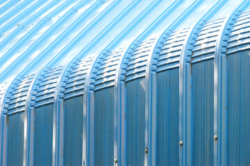 Closeup perspective view of blue structured roof with sunlight and shadow