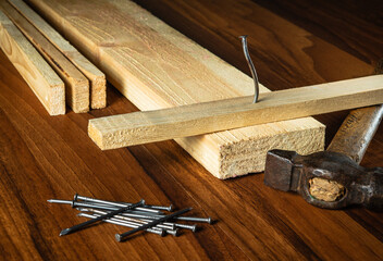 Carpenter workplace tools and wood planks. Working environment in a carpentry workshop
