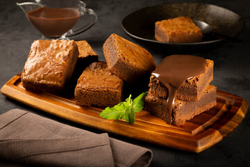 Chocolate brownies with chocolate sauce and mint leaves
