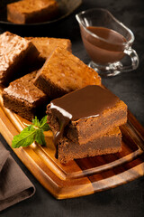 Chocolate brownies with chocolate sauce and mint leaves