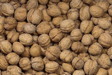 Walnut heap closeup. Vegan food. Concept of healthy food.