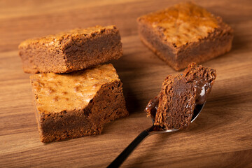 Chocolate brownie. Spoon with piece of chocolate brownie.