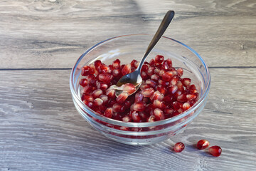 Juicy ripe pomegranate grains. Concept of vegan dessert.