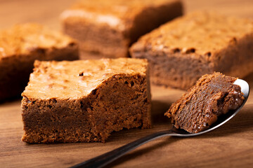Chocolate brownie. Spoon with piece of chocolate brownie.