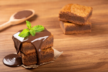 Chocolate brownies with chocolate sauce and mint leaves