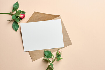 Invitation card mockup with fresh roses bouquet on paper background