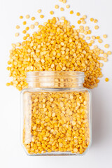 Close up of Organic Bengal Gram (Cicer arietinum) or split yellow chana dal and in a glass jar. Top view 