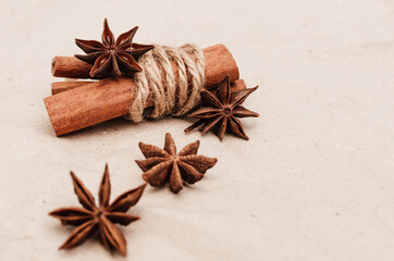 Warming spices - cinnamon and star anise with wooden spoons, chopsticks on vintage wood table.