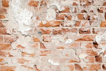 Demolished stone wall with exposed bricks, red, cracked and damaged brick wall, background for template, no person
