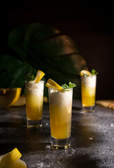 Photo for bar concept or magazines. Glasses of melon drink on dark background. Fresh and summer drink. laid out in layers with whipped cream