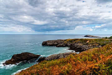 Fototapeta na wymiar Scenic view of rocky seascape, cloudy day of summer. The Whale of Orinon, Sonabia, Cantabria, Spain