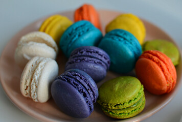 Multicolored macaroons on a plate, close up  