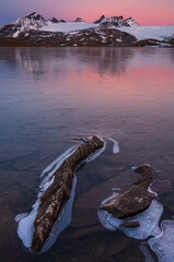 Ice on lake in front of mountains