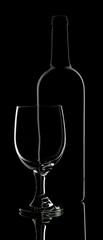 Glass of Wine and Wine Bottle on a black background, Low  key photo