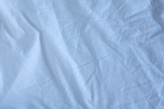 White satin fabric texture. Crumpled
