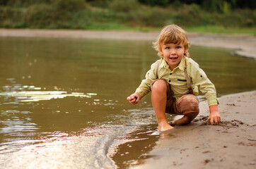 little child playing in the water