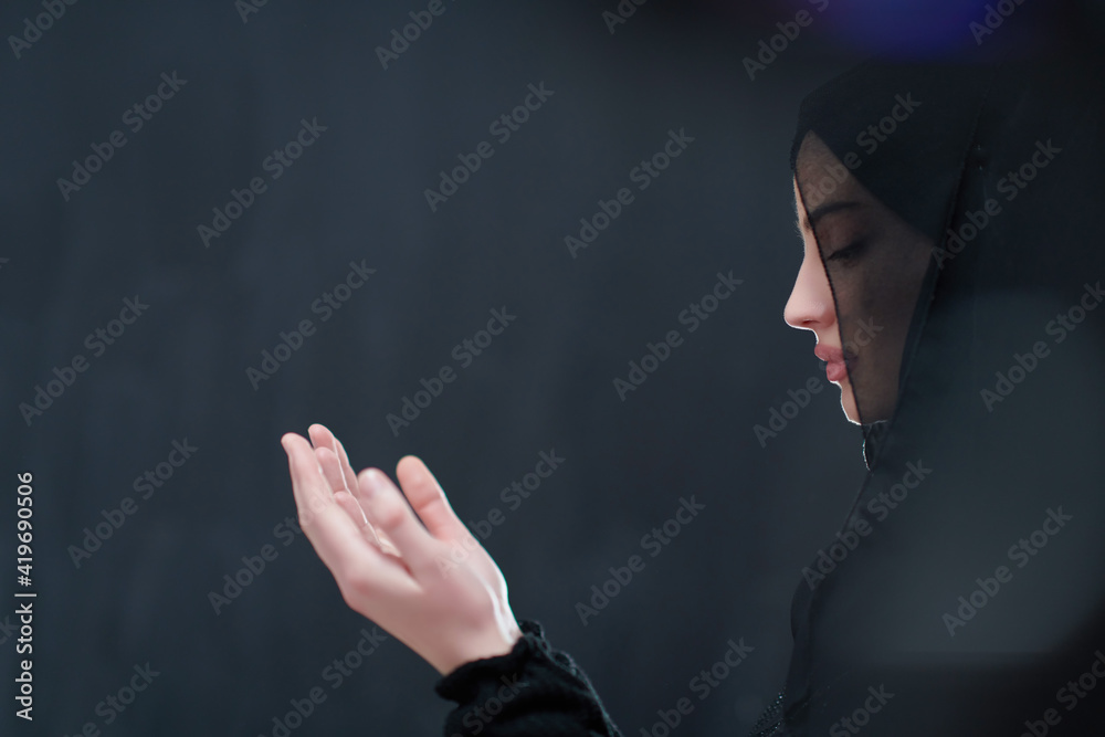 Wall mural Portrait of young Muslim woman making dua