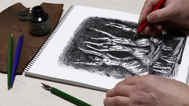 The process of drawing a sketch of dancers with pen and ink in a sketchbook