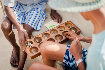 Two men play mancala on Cape Verde