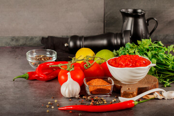 Salsa Sauce. Spicy, colorful Mexican salsa sauce with hot peppers and tomatoes on a dark background.Classic homemade Italian tomato sauce  for pasta  pizza in  on wooden background.