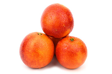 A slide made of four red oranges. Water droplets are visible on the peel.