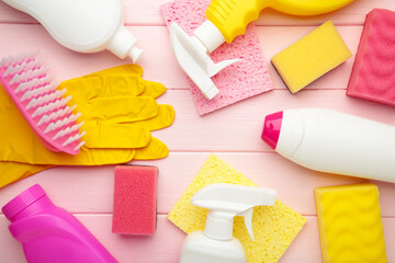 Set of cleaning tools on a pink background