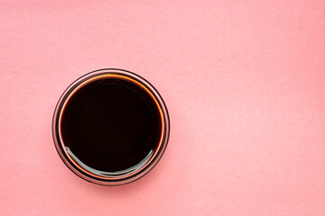 a small bowl of yacon syrup against pink paper with a copy space,  a powerful prebiotic sweetener...