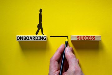 Onboarding success symbol. Wooden blocks with words 'onboarding success'. Businessman hand....