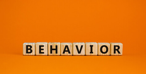Behavior symbol. Wooden cubes with word 'behavior'. Beautiful orange background. Business, psychology and behavior concept. Copy space.
