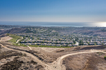 Aerial View Of A Coastal California Suburban Community. Ocean and Hiking Trails Frame an Upscale Coastal Community