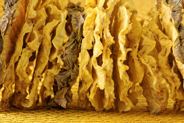 Texture of yellow fruit dried pineapple slices. Juicy close-up abstract background.