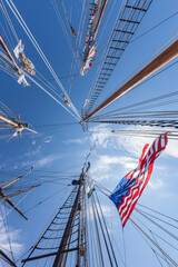USA, Massachusetts, Cape Ann, Gloucester. Gloucester Schooner Festival, schooner masts and US flag.