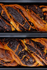 Braided cake with chocolate close-up view background. Yeast-risen dough twisted krantz cake top...