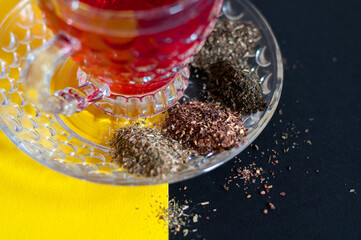 Red tea cup isolated on black and yellow background