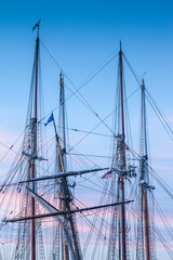 USA, Massachusetts, Cape Ann, Gloucester. Gloucester Schooner Festival, schooner masts at dusk.