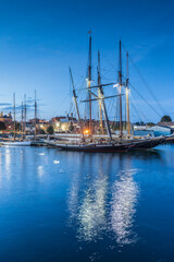 Fototapeta na wymiar USA, Massachusetts, Cape Ann, Gloucester. Gloucester Schooner Festival, schooners in Gloucester Harbor at dusk
