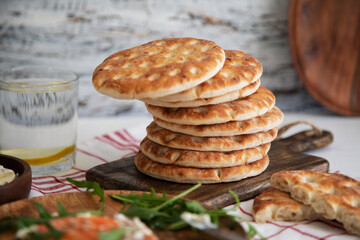 Fresh tortillas stacked on wooden table
