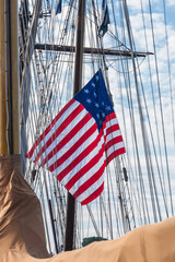USA, Massachusetts, Cape Ann, Gloucester. Gloucester Schooner Festival, schooner masts and US flag.