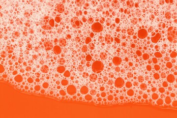 soap foam close-up on orange background. Beauty and hygiene concept.soap foam macro background.soap bubbles.Bath foam