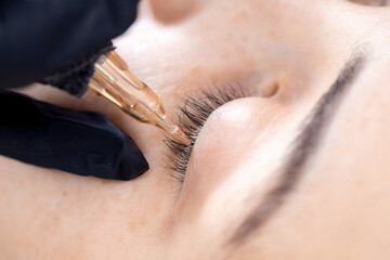 Contouring woman eye permanent make up tattoo black in beauty salon