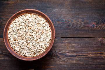 Dry oatmeal in a bowl. Oatmeal is a delicious healthy diet food.