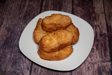 French toasts on a wooden plate. A delicious meal.