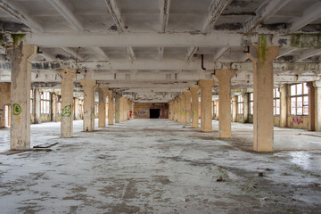 a frozen factory floor without glass stands empty